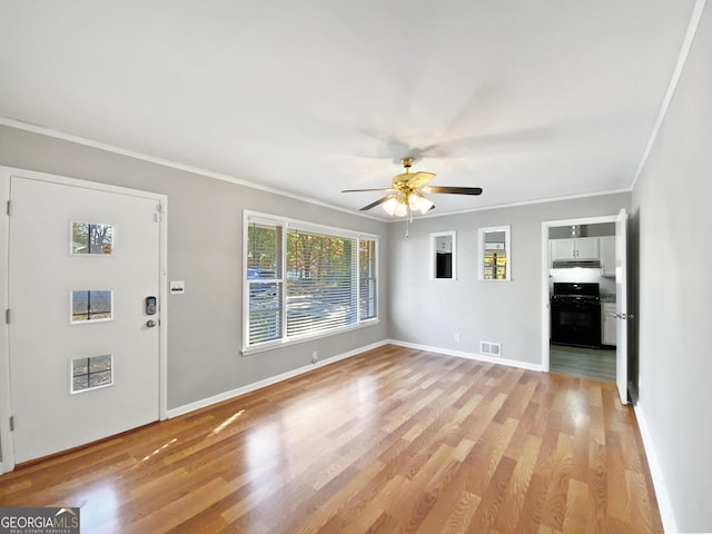 unfurnished living room featuring light wood-type flooring, ceiling fan, and crown molding