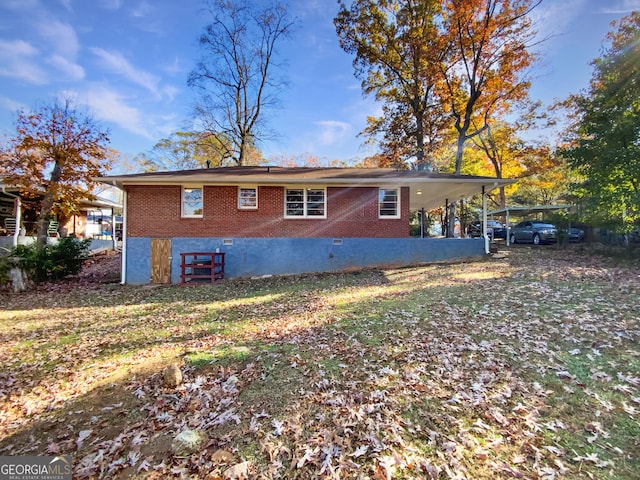 rear view of house featuring a yard