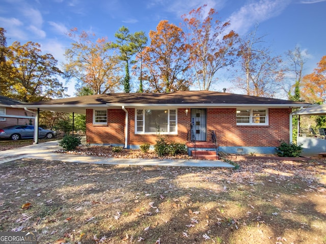 ranch-style house featuring a carport