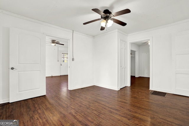 unfurnished room featuring crown molding, ceiling fan, and dark wood-type flooring