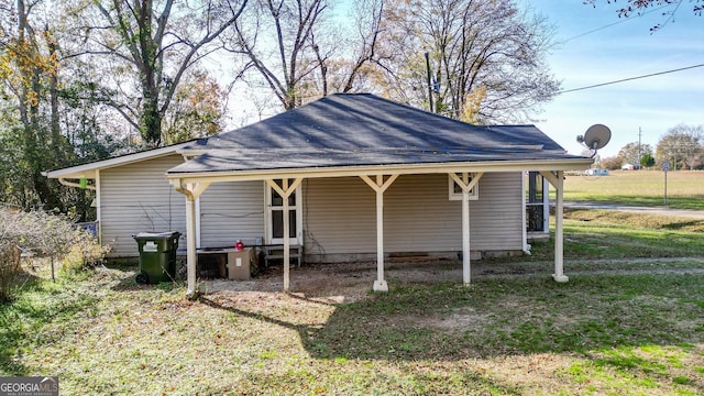 rear view of house featuring a yard