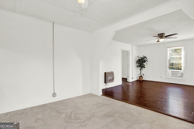 empty room with heating unit, hardwood / wood-style flooring, cooling unit, and ceiling fan