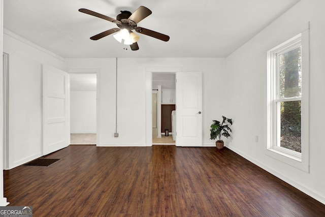 spare room featuring ceiling fan and dark wood-type flooring