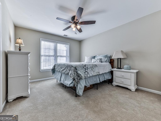 bedroom featuring light colored carpet and ceiling fan