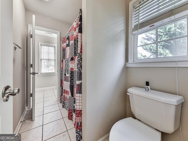 bathroom with toilet and tile patterned flooring