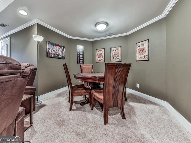 carpeted dining space featuring ornamental molding