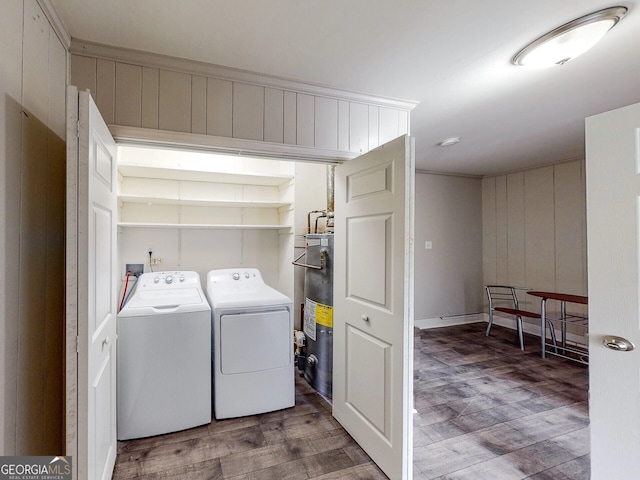 laundry area featuring hardwood / wood-style flooring, water heater, wooden walls, and washing machine and clothes dryer