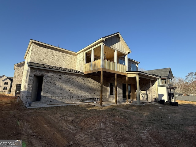 back of property featuring a balcony