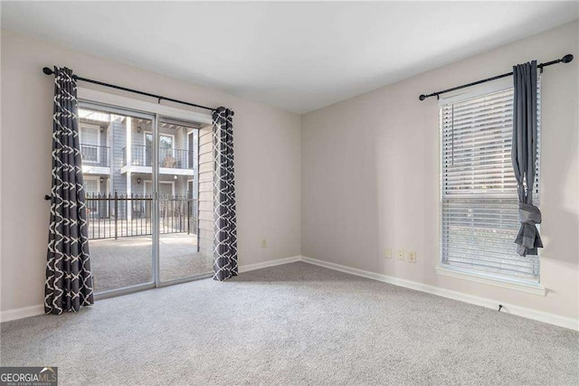 spare room with carpet floors and baseboards