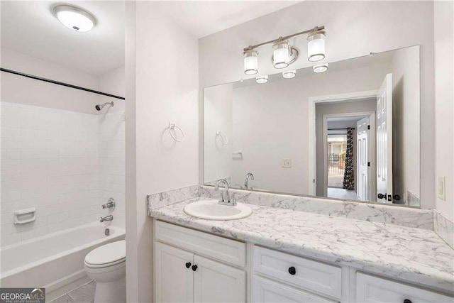 full bathroom featuring toilet, bathing tub / shower combination, and vanity