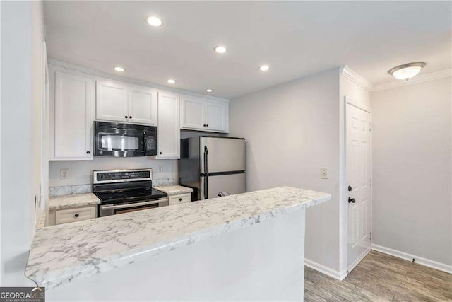 kitchen with recessed lighting, appliances with stainless steel finishes, light wood-style floors, white cabinetry, and baseboards