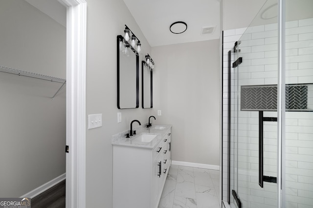 bathroom featuring vanity and an enclosed shower