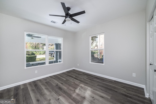 unfurnished room with ceiling fan and dark wood-type flooring