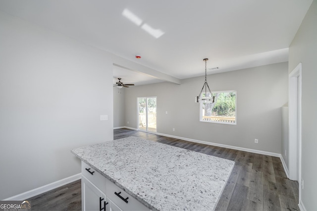 kitchen with dark hardwood / wood-style flooring, white cabinets, a healthy amount of sunlight, and decorative light fixtures