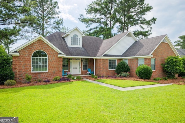 view of front of home with covered porch and a front yard