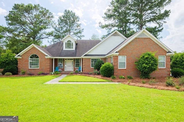 3798 Bermuda Run Dr, Valdosta, GA 31605 - traditional-style house with brick siding, a front yard, roof with shingles, and a porch