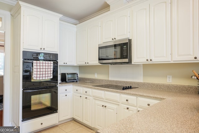 3798 Bermuda Run Dr, Valdosta, GA 31605 - kitchen featuring black appliances, white cabinets, light tile patterned flooring, light countertops, and ornamental molding