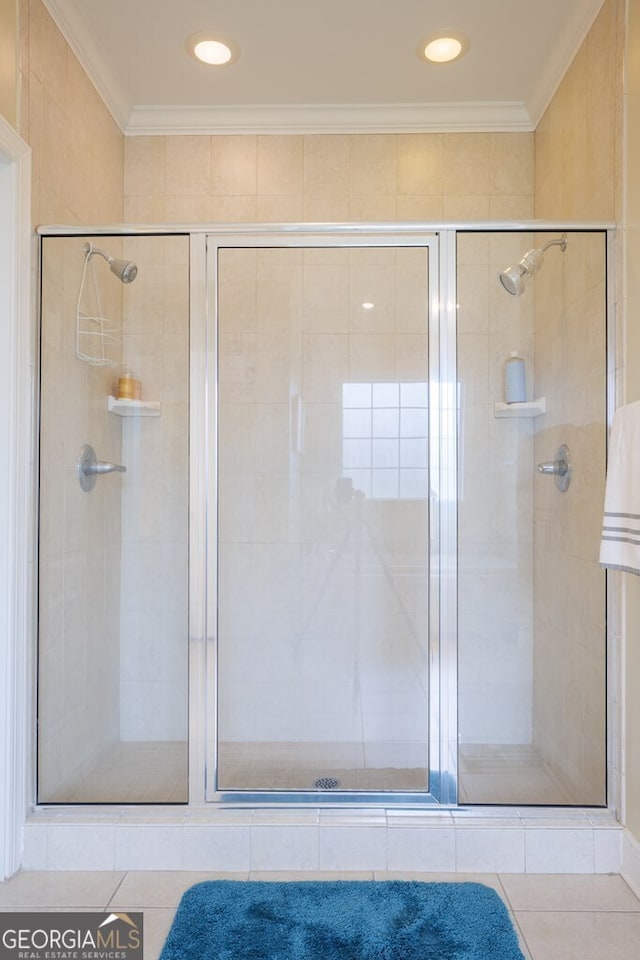 bathroom featuring tile patterned floors, crown molding, and walk in shower