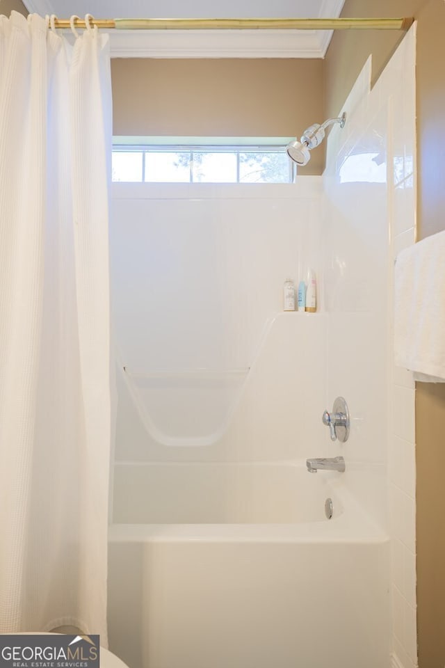 bathroom with shower / bath combo with shower curtain