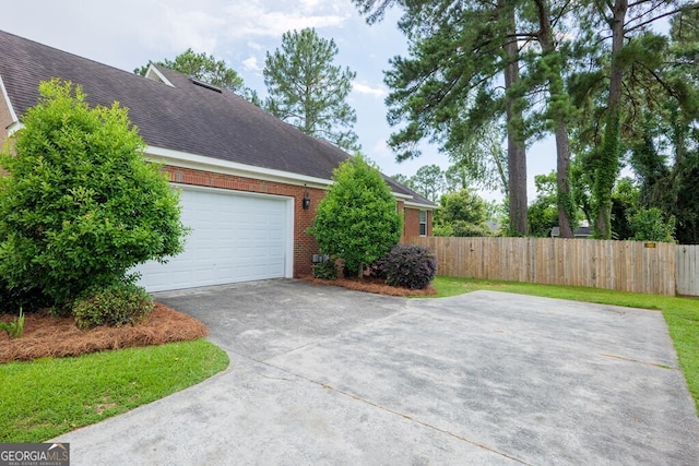 3798 Bermuda Run Dr, Valdosta, GA 31605 - view of side of home featuring brick siding, roof with shingles, driveway, and an attached garage