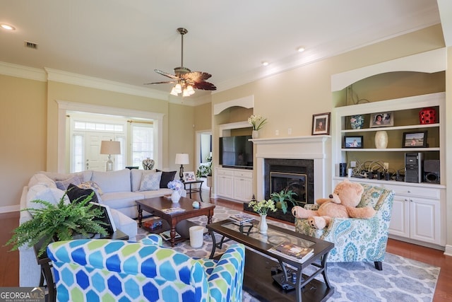 living room featuring hardwood / wood-style floors, ceiling fan, and crown molding