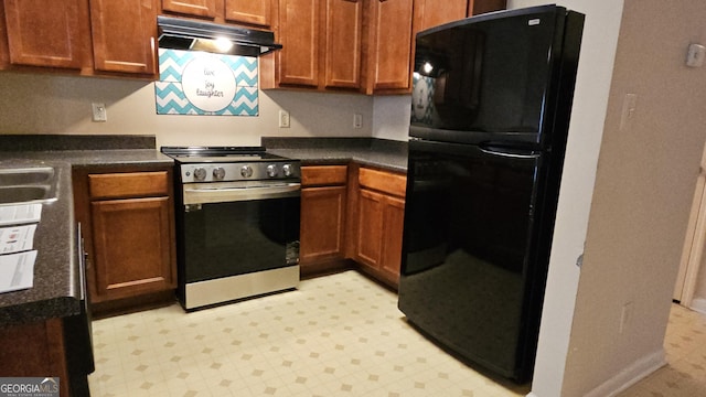 kitchen with black refrigerator and stainless steel range oven