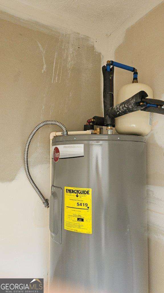 utility room featuring water heater