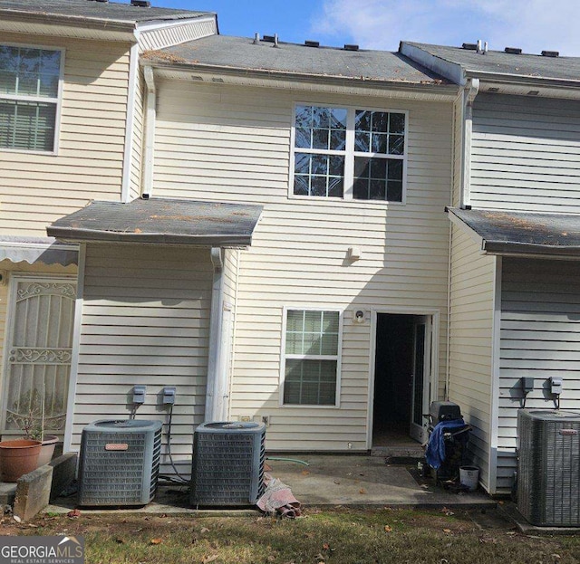 back of house featuring central AC unit and a patio area