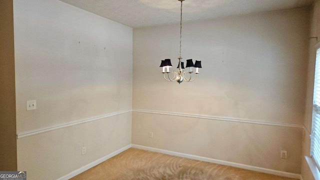 unfurnished dining area featuring carpet flooring and a notable chandelier