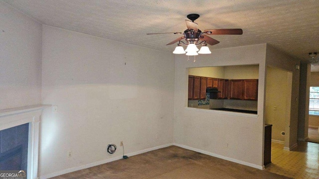 interior space featuring ceiling fan and a textured ceiling