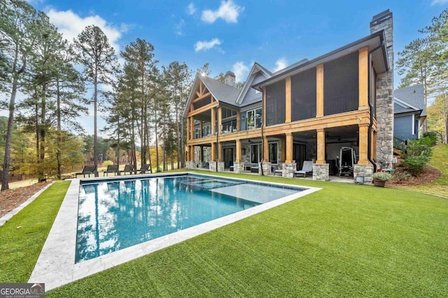 back of house with a lawn and a patio area