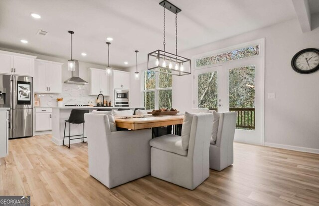 dining room featuring light wood-type flooring and sink