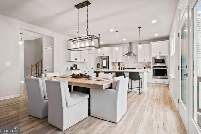 dining area featuring light wood-type flooring and sink