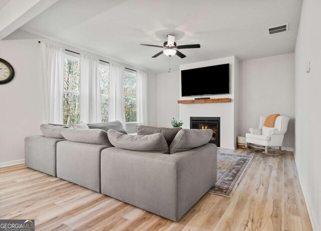 living room featuring light wood-type flooring and ceiling fan