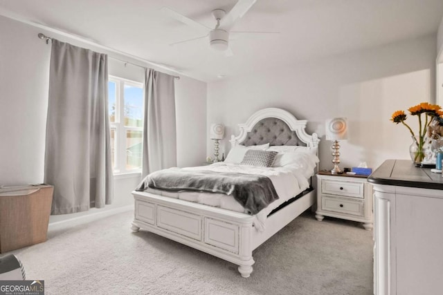 bedroom featuring light colored carpet and ceiling fan