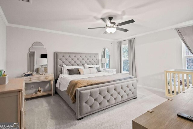 bedroom featuring ceiling fan, light colored carpet, and ornamental molding