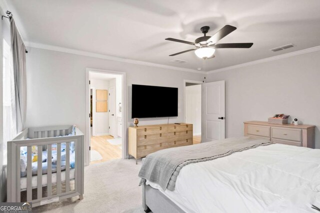 carpeted bedroom featuring ceiling fan, ornamental molding, and connected bathroom