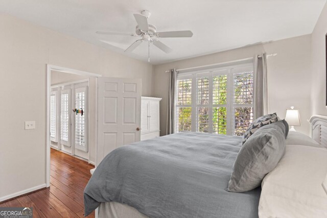 bedroom with ceiling fan and dark hardwood / wood-style floors