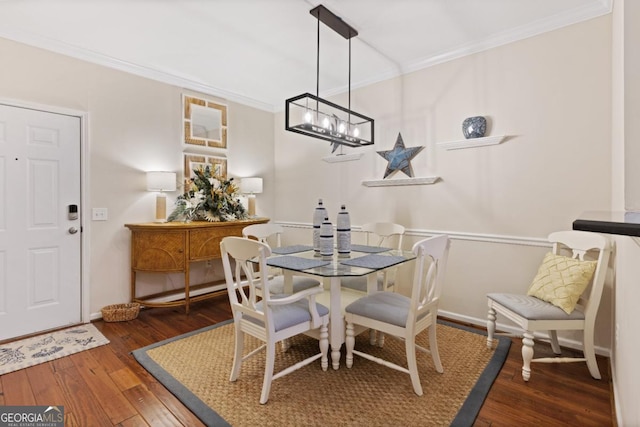 dining area featuring crown molding and dark hardwood / wood-style floors