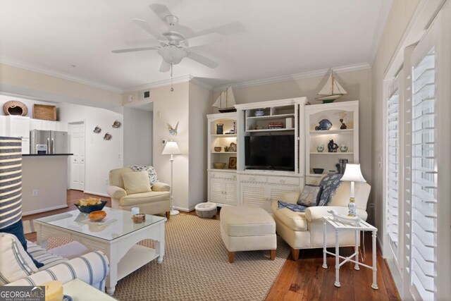 living room featuring ceiling fan, dark hardwood / wood-style flooring, and crown molding