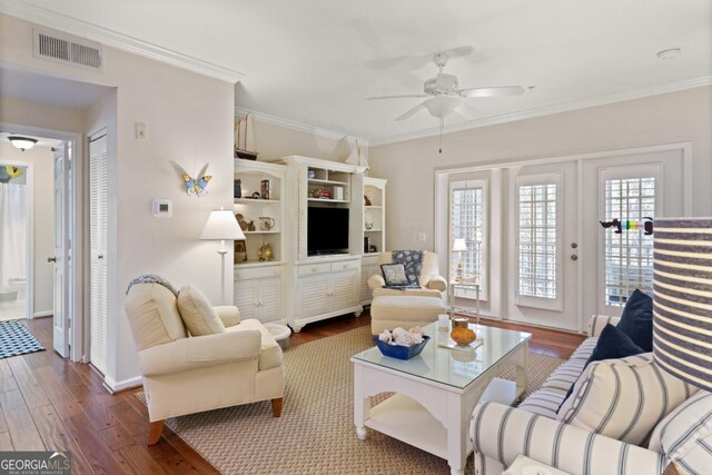 living room featuring crown molding, ceiling fan, and dark wood-type flooring