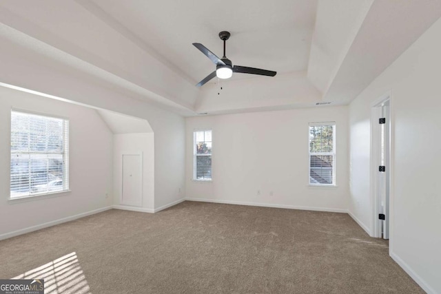 empty room with light colored carpet, plenty of natural light, and ceiling fan