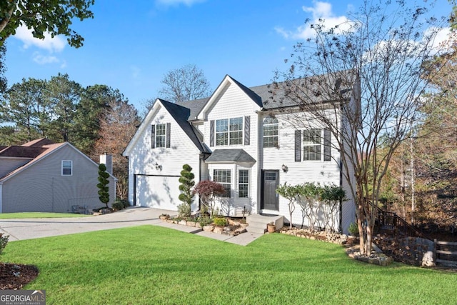 view of property featuring a front lawn and a garage