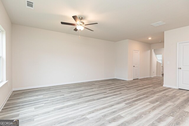 spare room featuring ceiling fan and light wood-type flooring