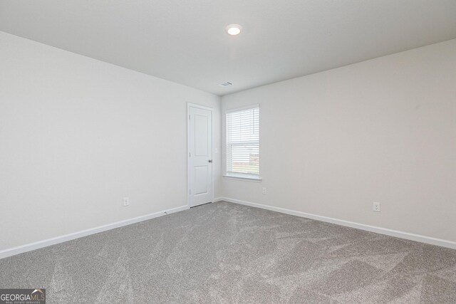 unfurnished room featuring carpet