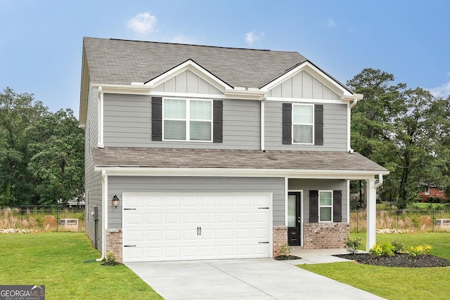 view of front of home with a front yard and a garage