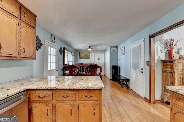 3615 Miller Bottom Rd, Loganville, GA 30052 - kitchen featuring kitchen peninsula, stainless steel dishwasher, light stone counters, ceiling fan, and light hardwood / wood-style floors