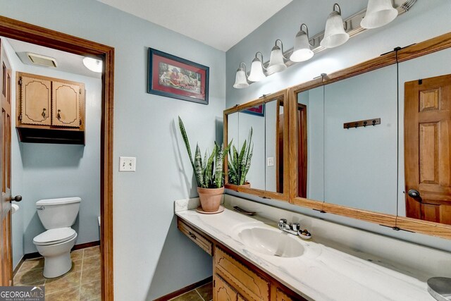 3615 Miller Bottom Rd, Loganville, GA 30052 - bathroom featuring tile patterned flooring, vanity, and toilet