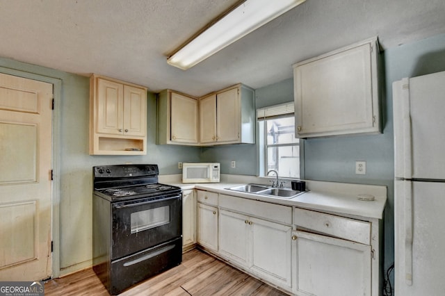 3615 Miller Bottom Rd, Loganville, GA 30052 - kitchen featuring a textured ceiling, sink, white appliances, and light hardwood / wood-style flooring