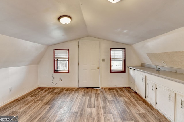 3615 Miller Bottom Rd, Loganville, GA 30052 - additional living space featuring light hardwood / wood-style flooring, vaulted ceiling, and a wealth of natural light